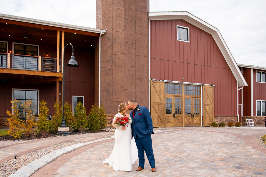 Bride and Groom posing outside of The Barn